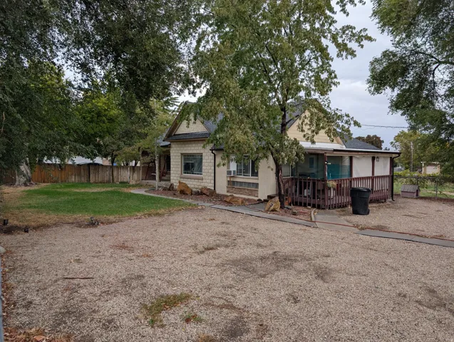 Back of property with roof with shingles