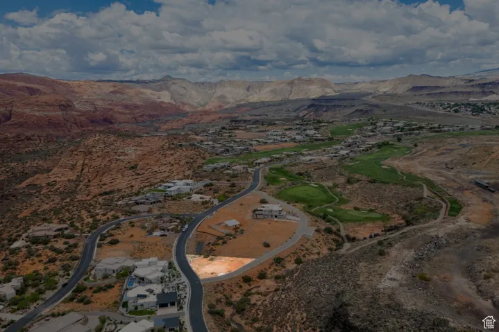 Aerial view of property's location featuring a mountainous background