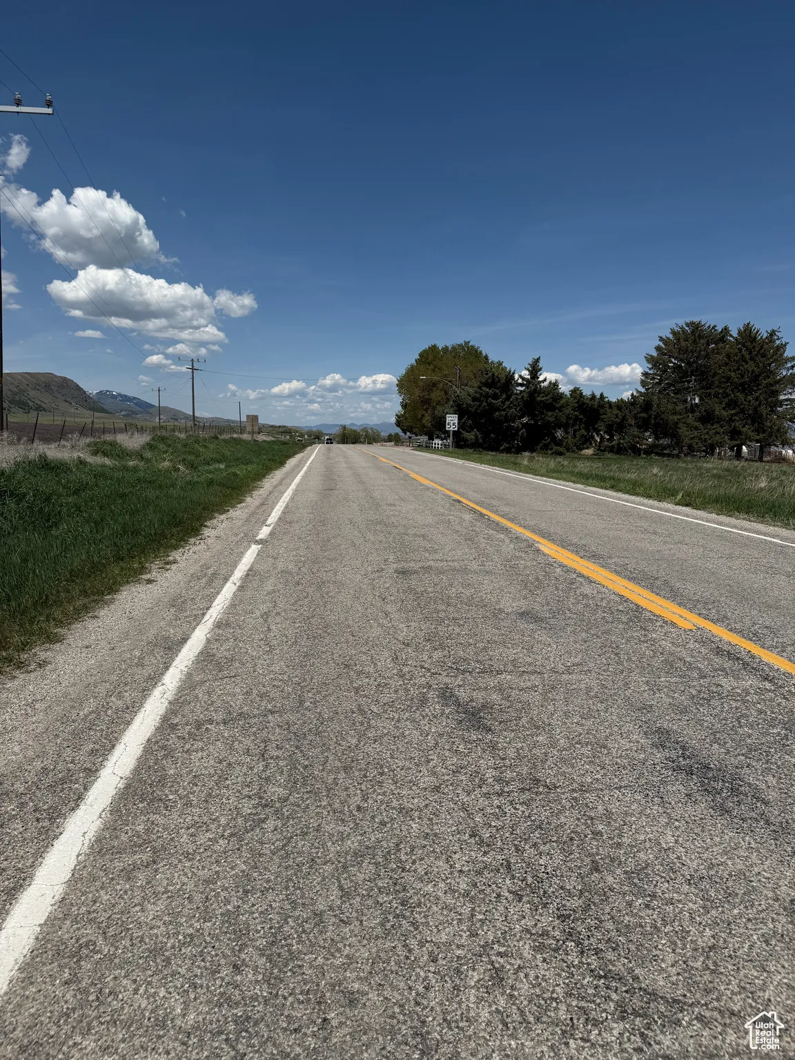 View of asphalt street featuring a mountain view