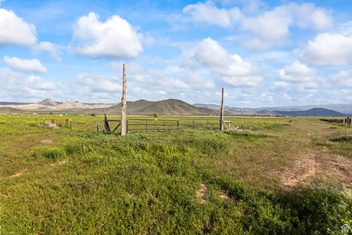 View of mountain backdrop featuring rural landscape and agricultural land