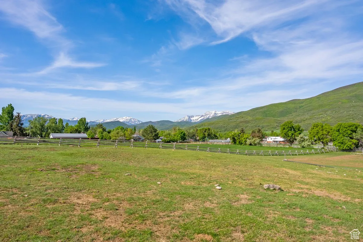 View of mountain backdrop with rural landscape and agricultural land