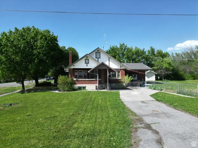View of front of home featuring concrete driveway and brick siding