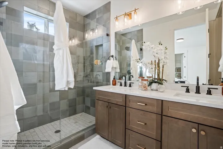 Bathroom with double vanity and a stall shower
