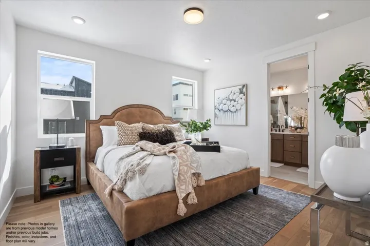 Bedroom featuring wood finished floors, ensuite bathroom, and recessed lighting