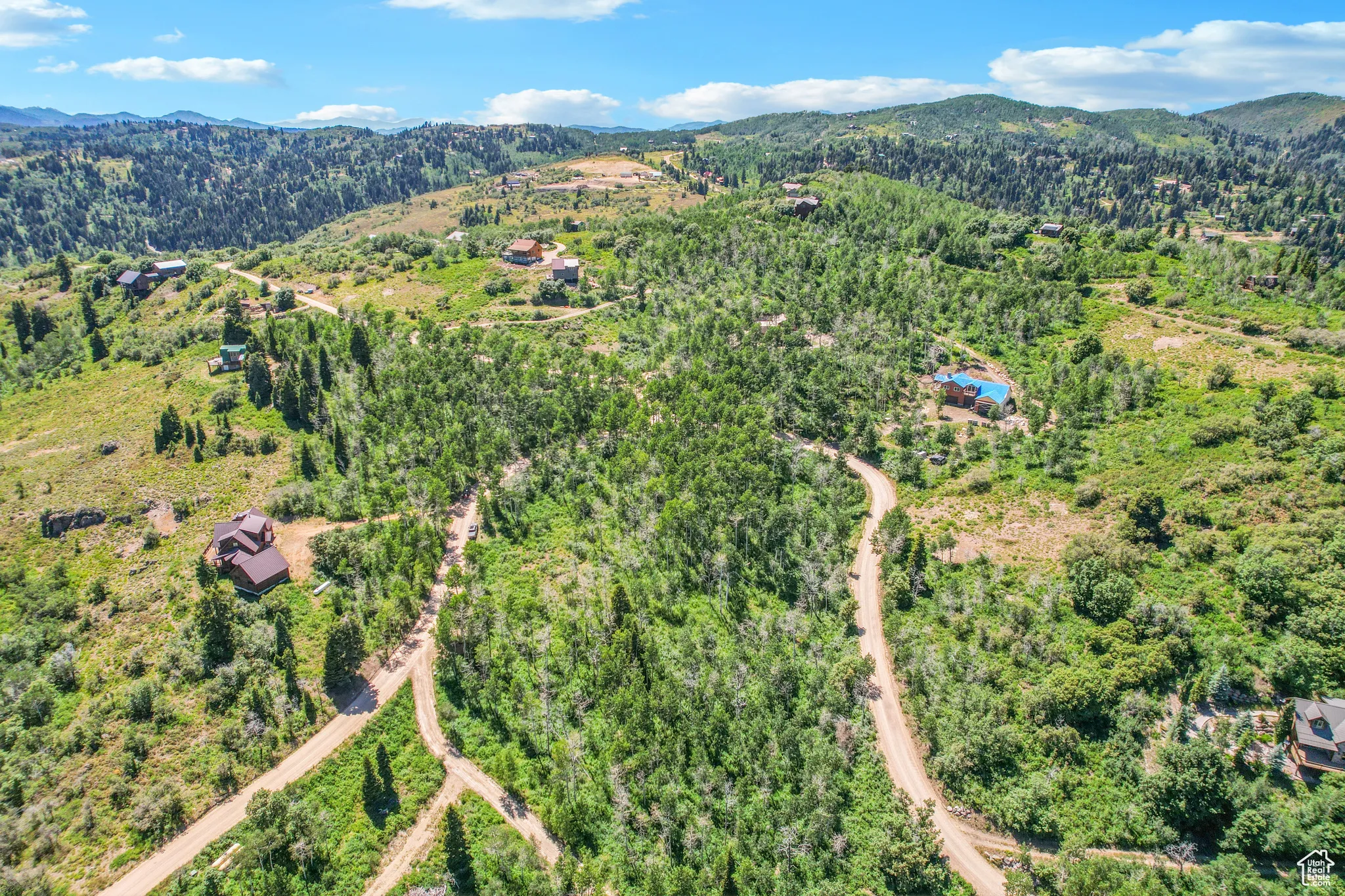 Aerial overview of property's location featuring a mountainous background