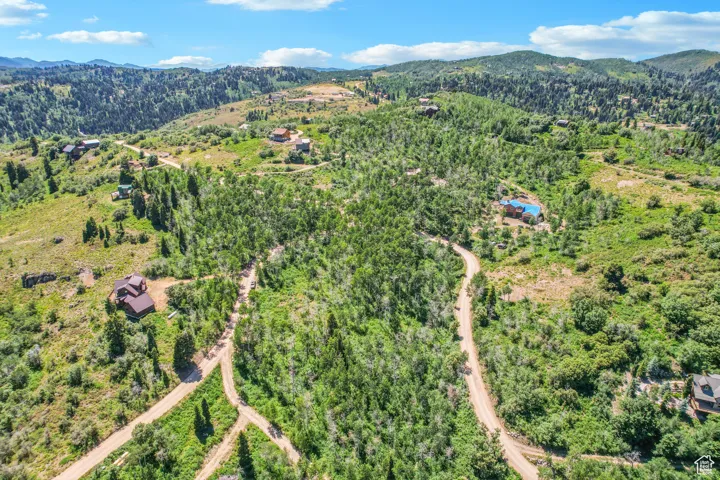 Aerial overview of property's location featuring a mountainous background