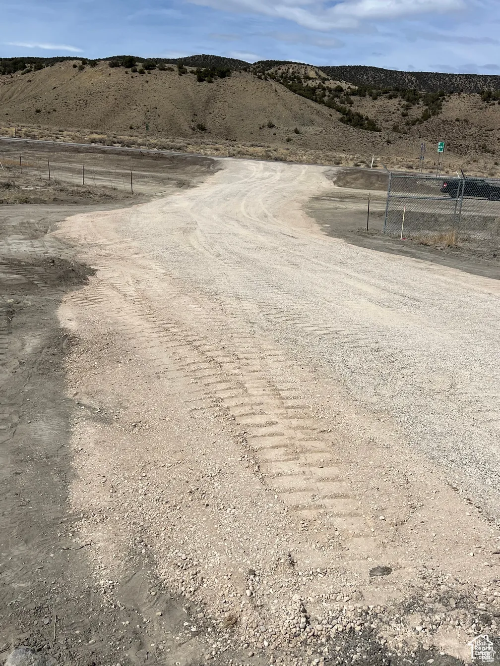 View of dirt / gravel road with a rural view