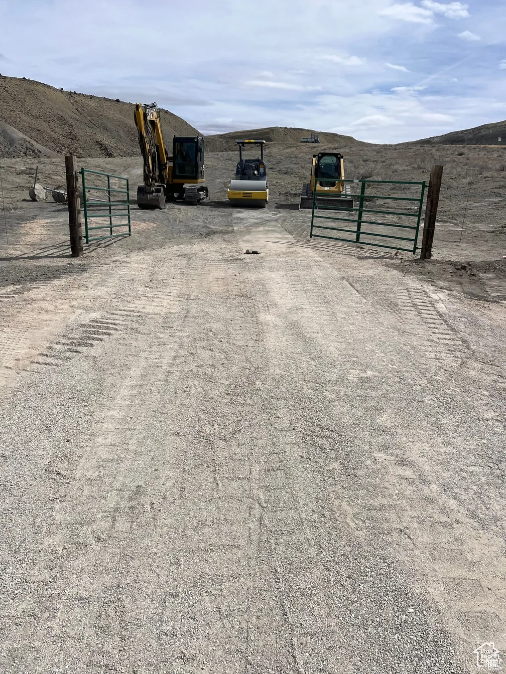 View of dirt / gravel road with a gated entry and a gate