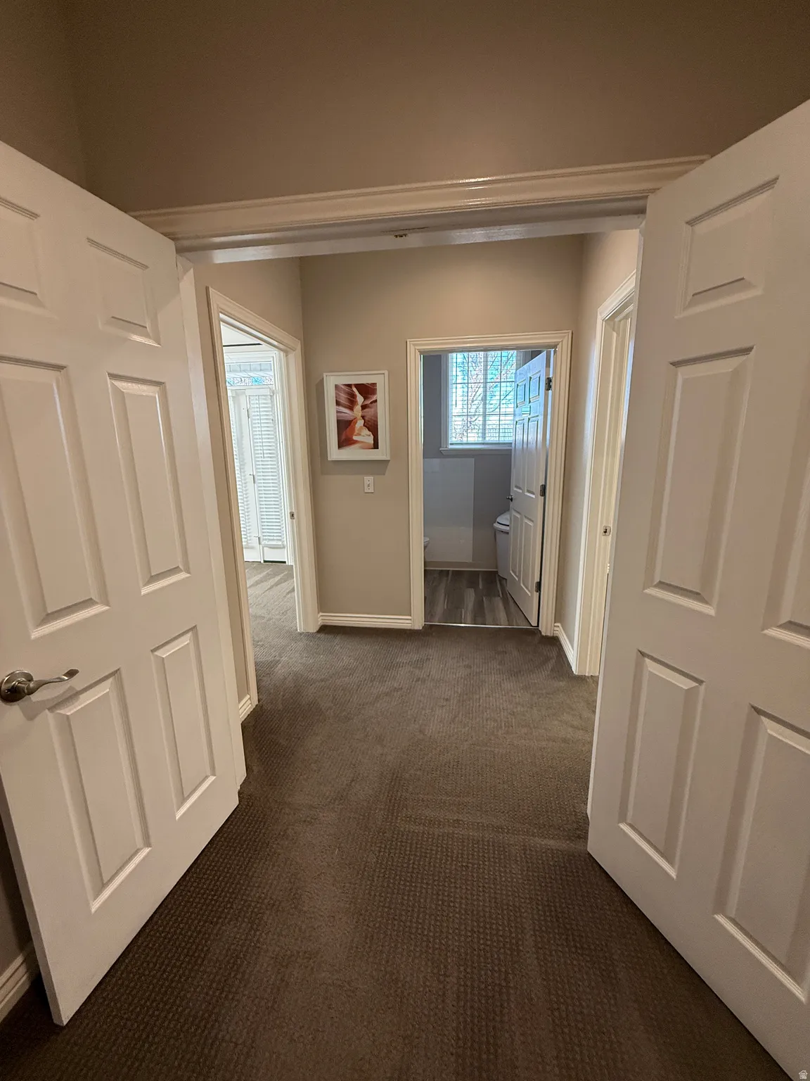 Private hallway featuring Suite 209 on the left, Shared Bathroom and Suite 210 on the right.