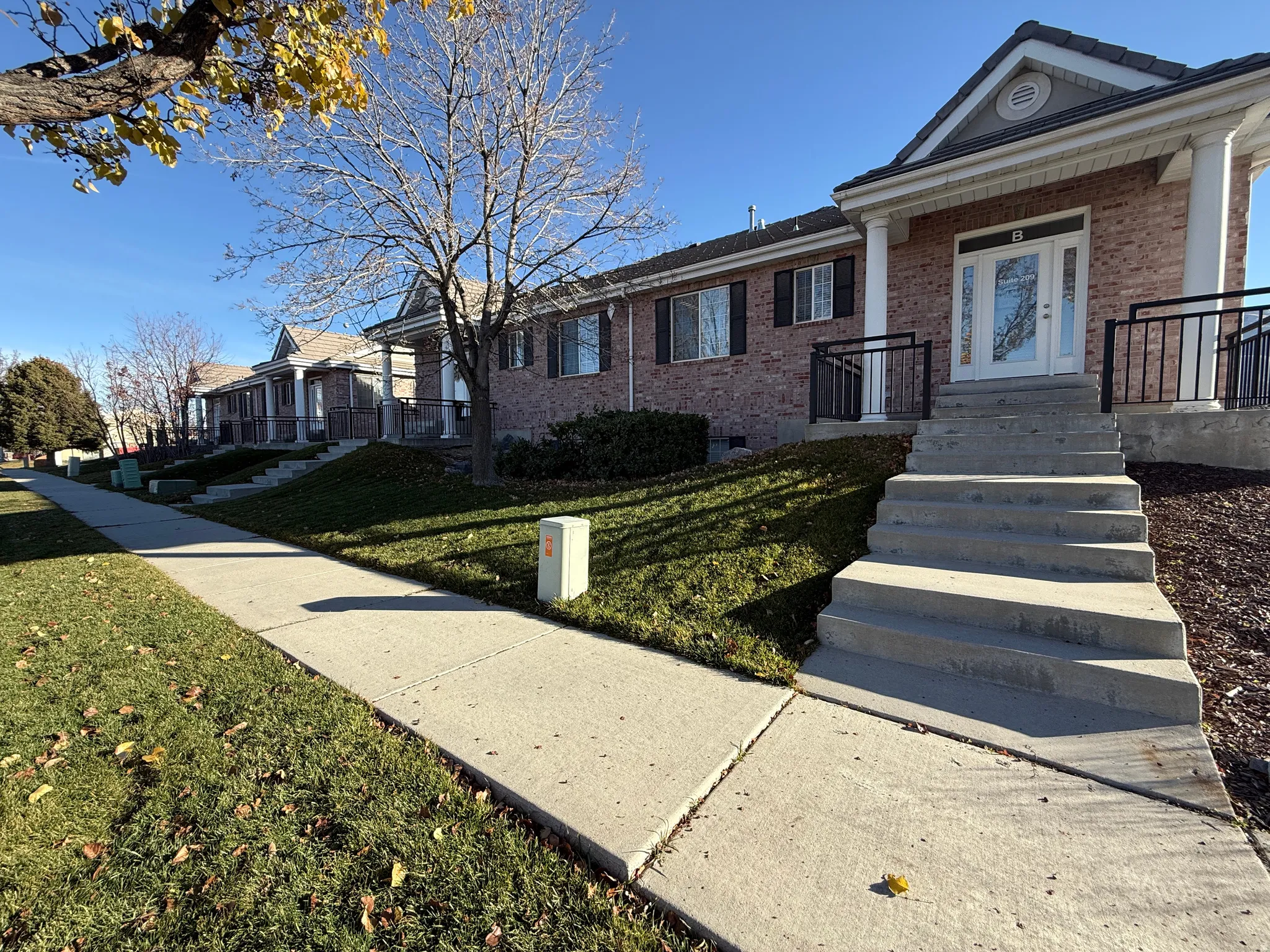 View of front of home featuring brick siding and a front lawn