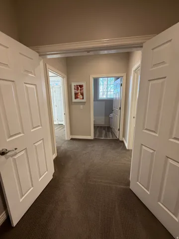 Private hallway featuring Suite 209 on the left, Shared Bathroom and Suite 210 on the right.
