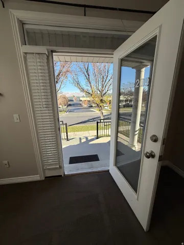 Suite 209 Doorway to outside featuring carpet and plenty of natural light