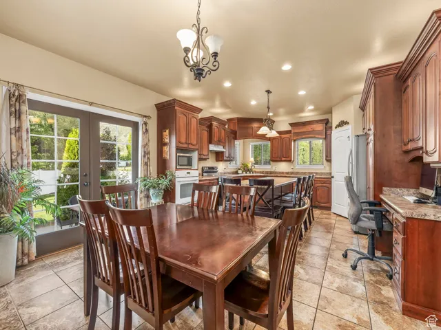 Dining space featuring recessed lighting, a desk, french doors, and a chandelier