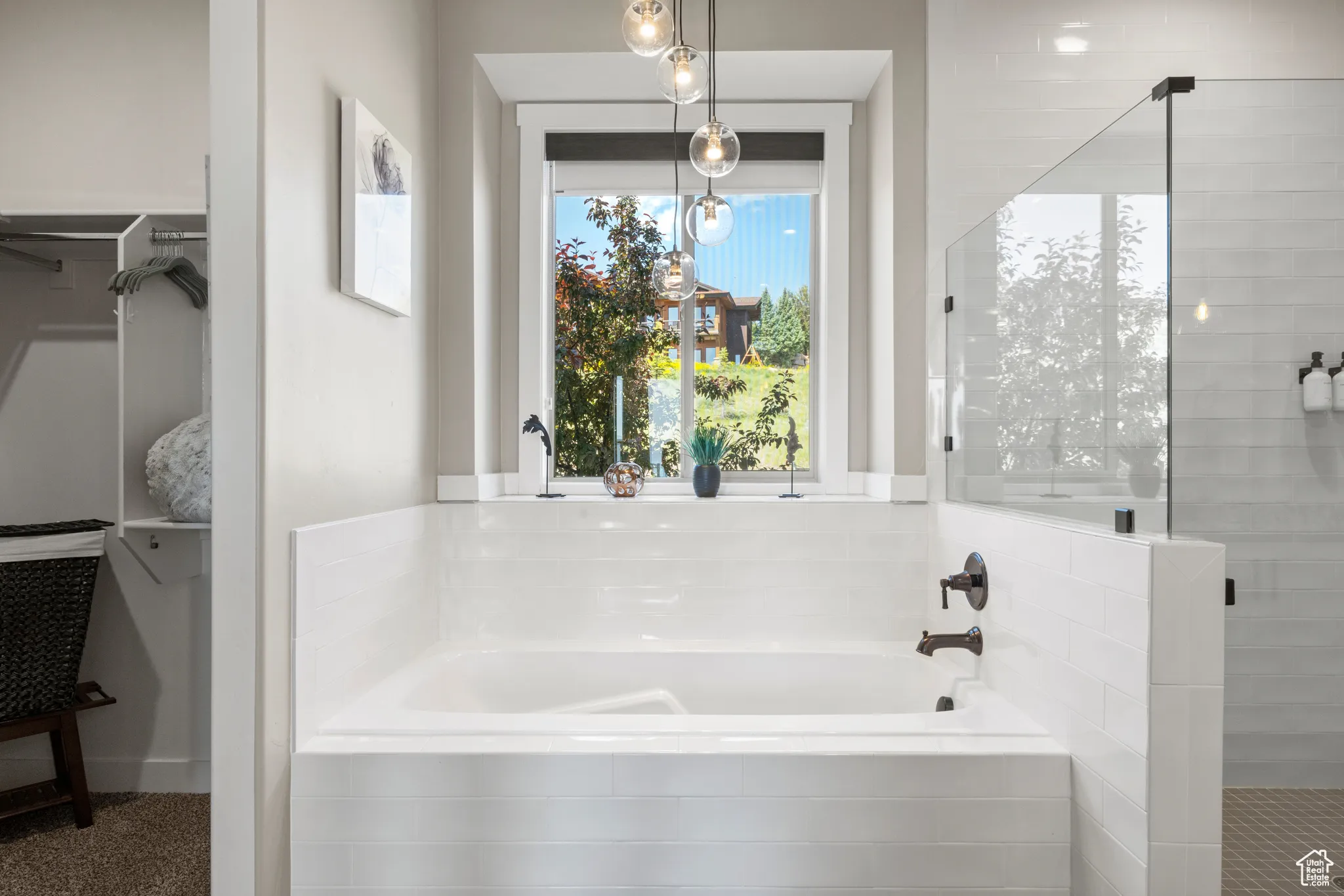 Full bath with a bath, a stall shower, and a walk in closet