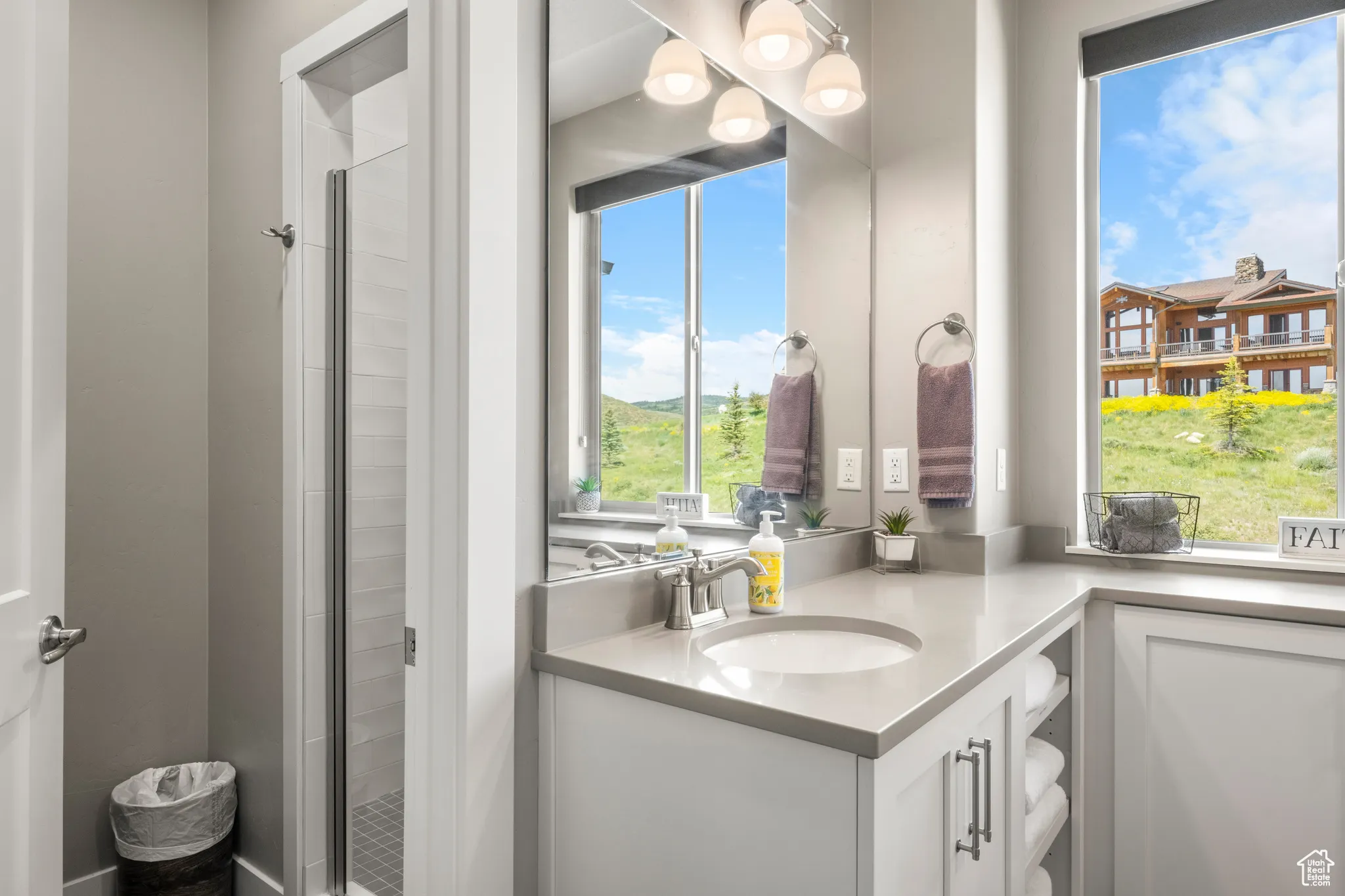 Full bath featuring vanity and a shower stall