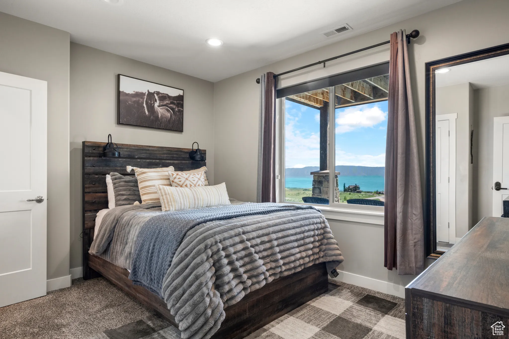 Bedroom with a water view, recessed lighting, and carpet floors