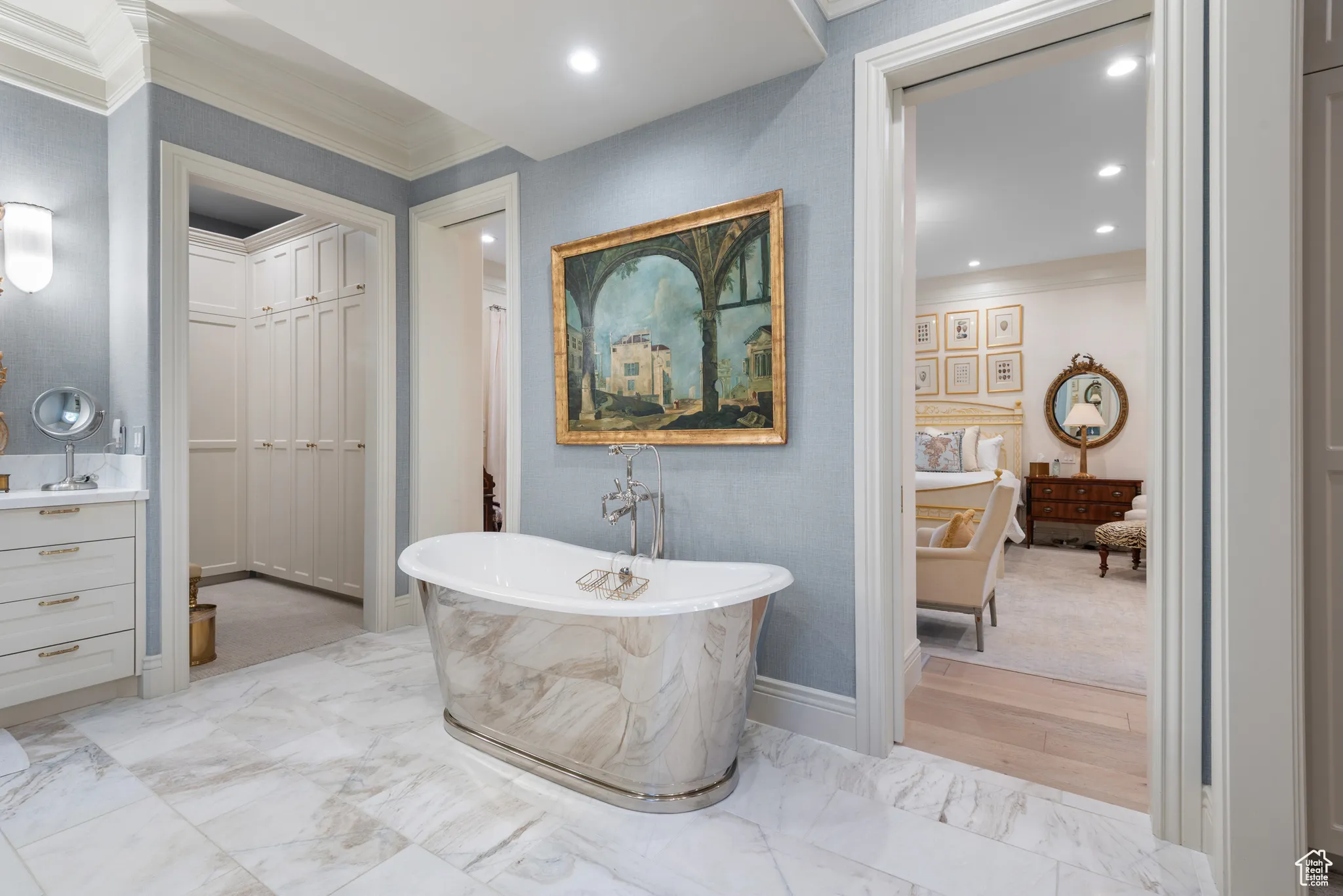 Full bath featuring crown molding, a soaking tub, marble finish flooring, recessed lighting, and vanity