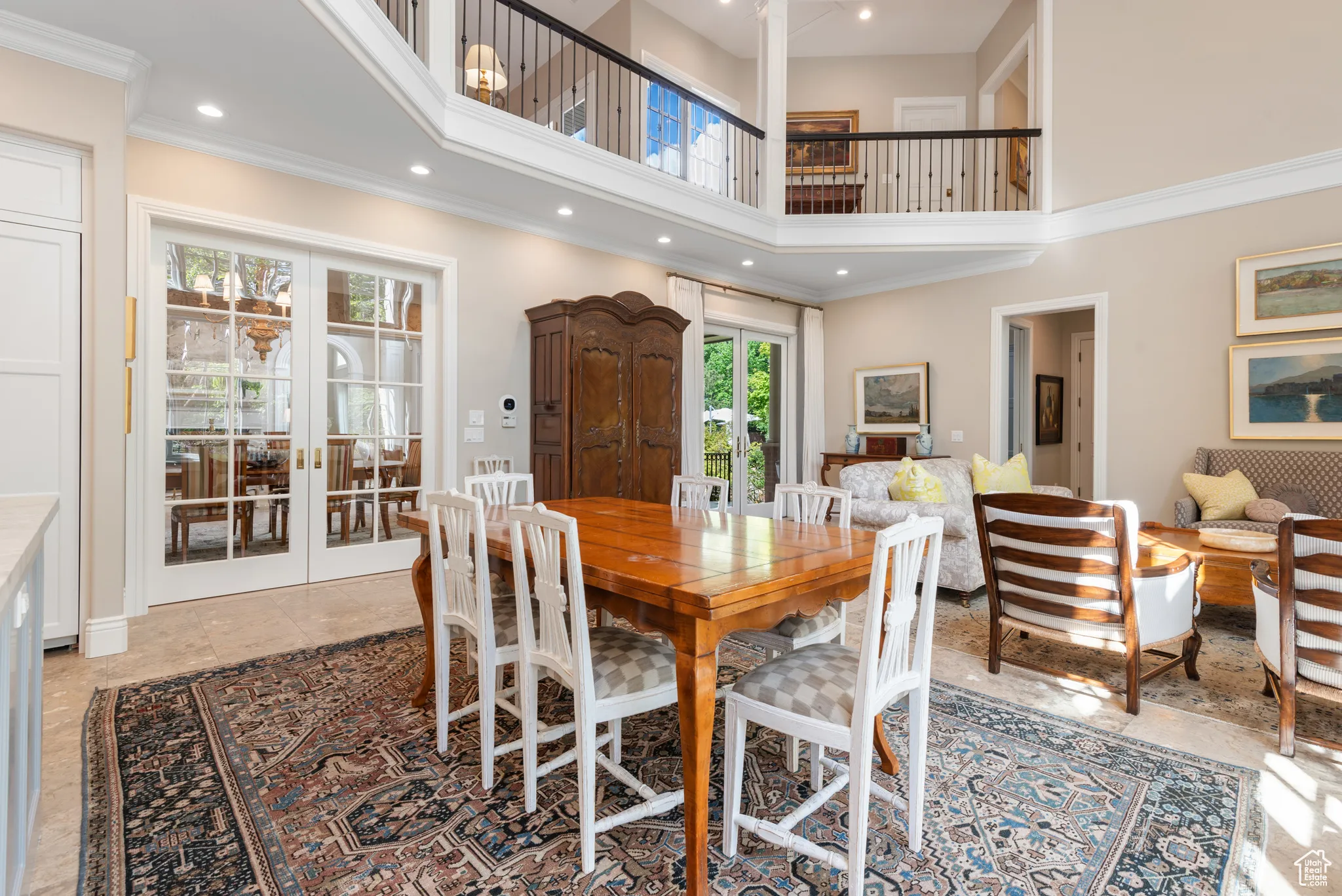 Dining space with french doors, a towering ceiling, and recessed lighting