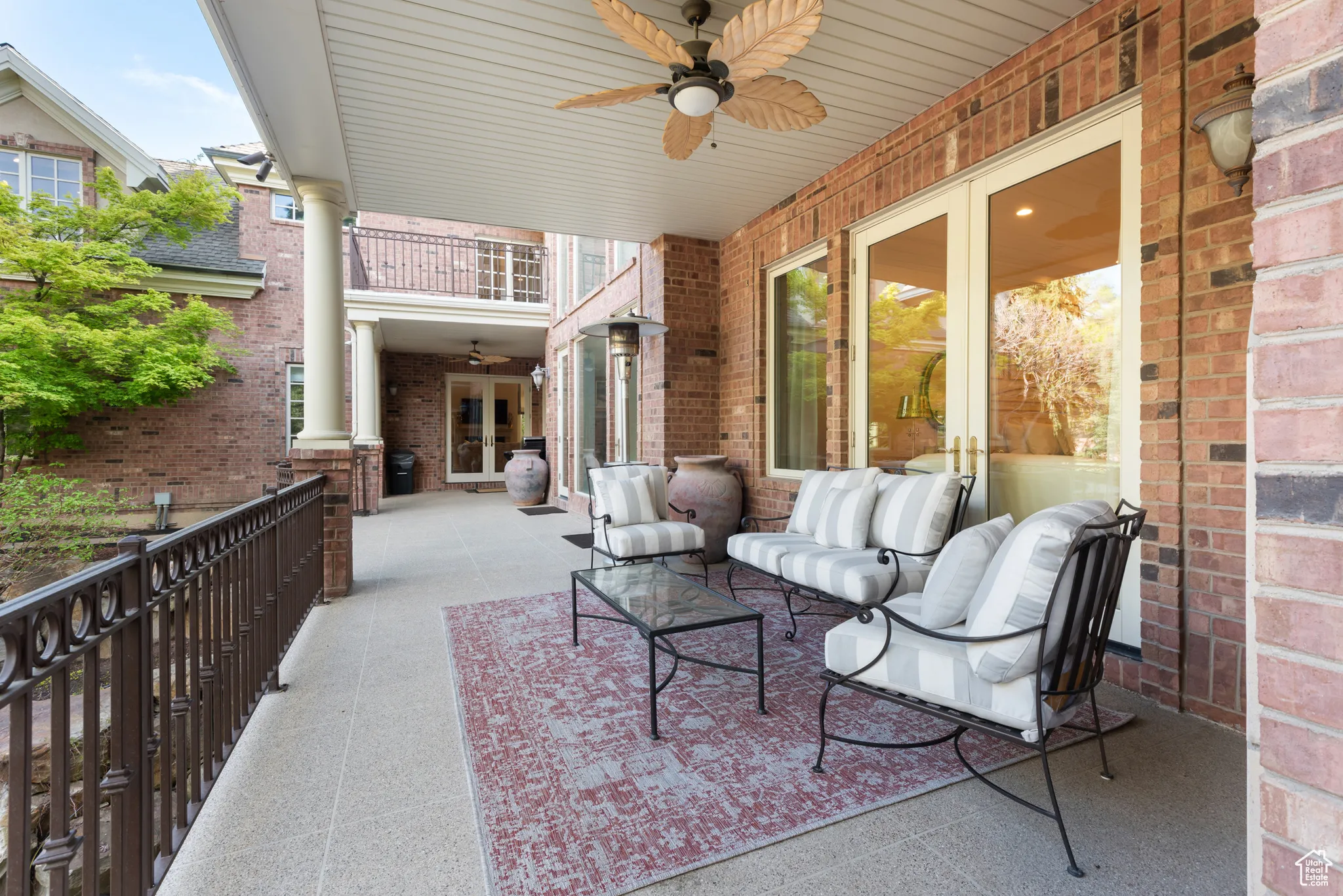 View of patio / terrace with french doors, ceiling fan, a balcony, and an outdoor living space