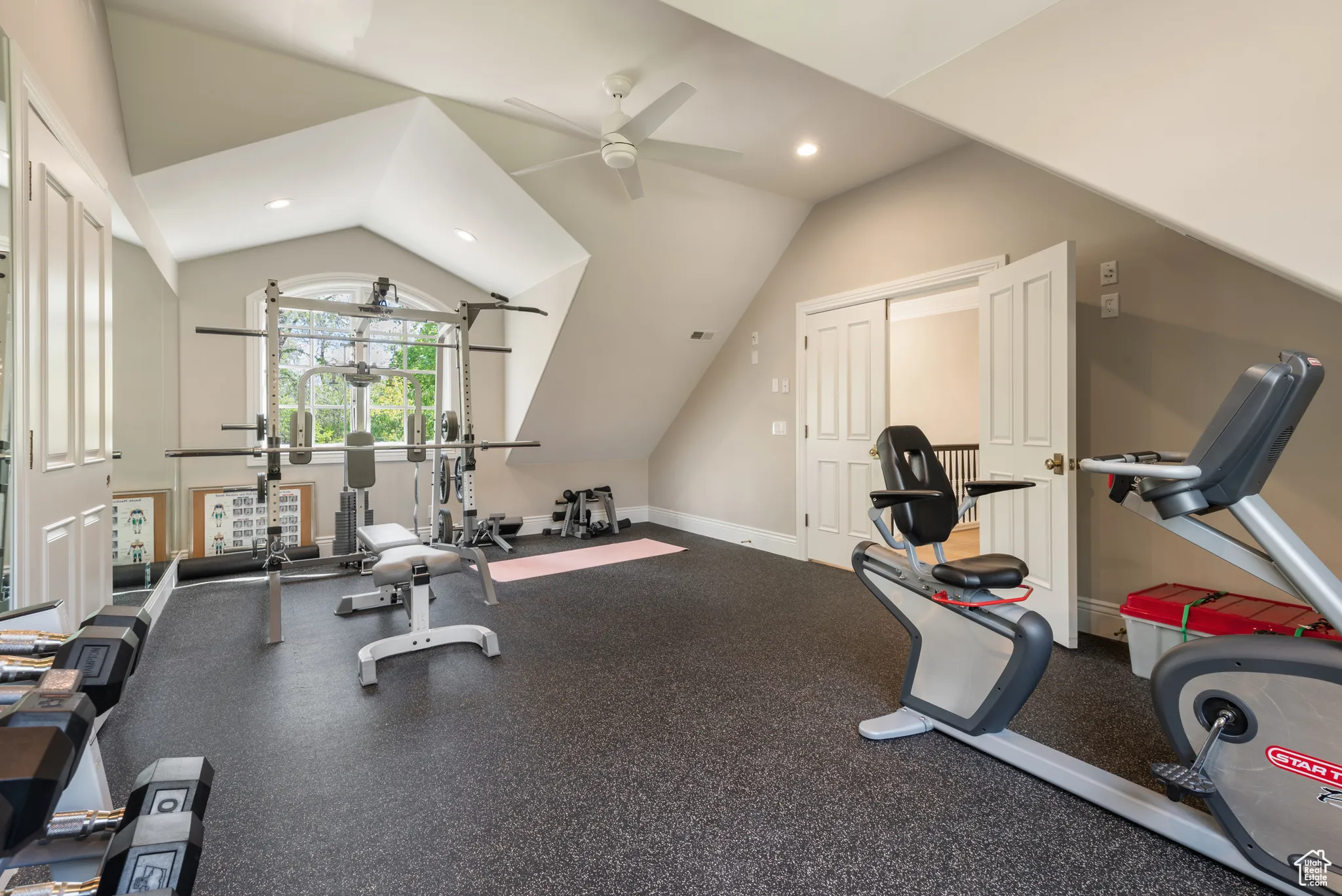 Exercise room with vaulted ceiling, a ceiling fan, and recessed lighting