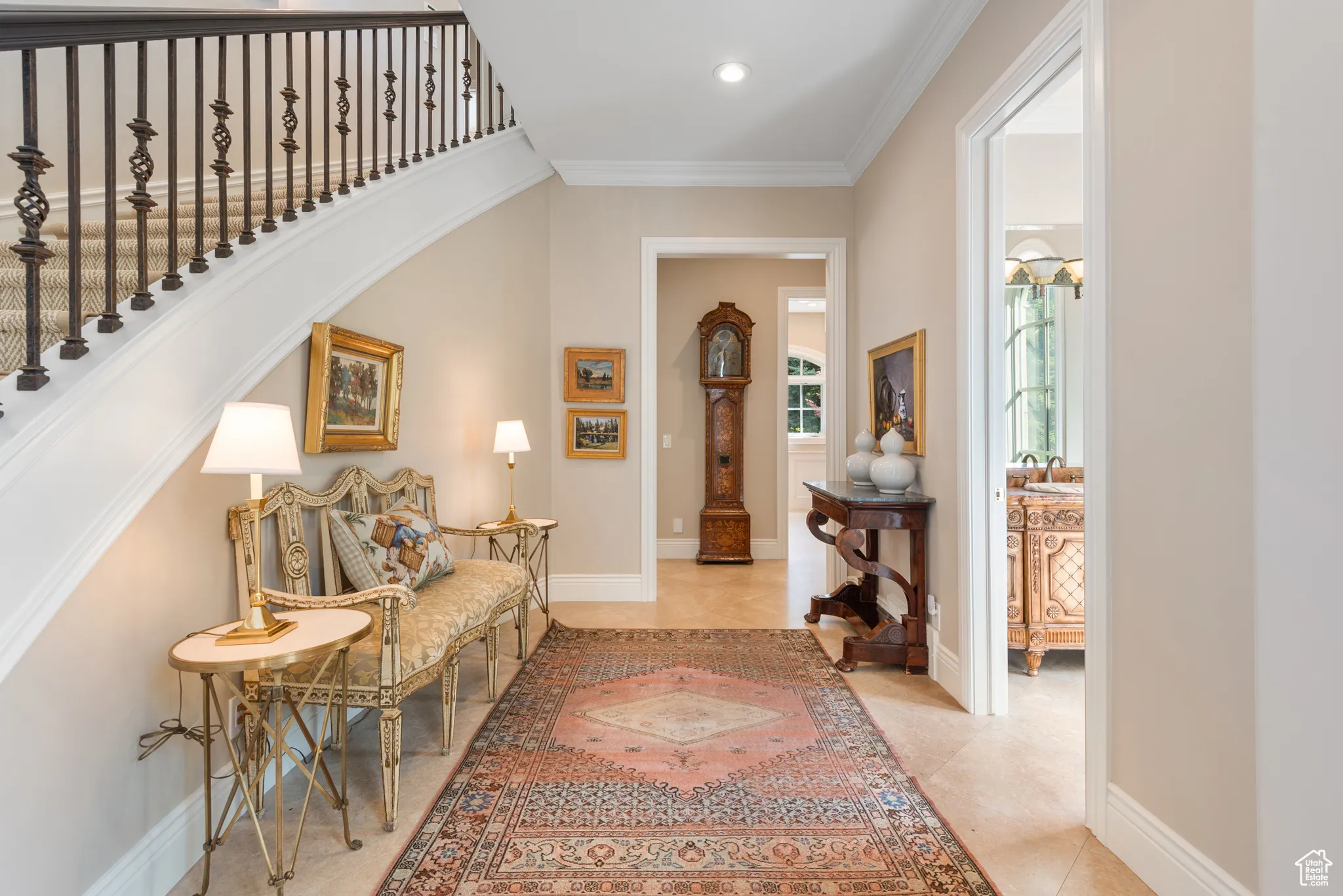 Tiled foyer with crown molding, baseboards, stairs, and recessed lighting