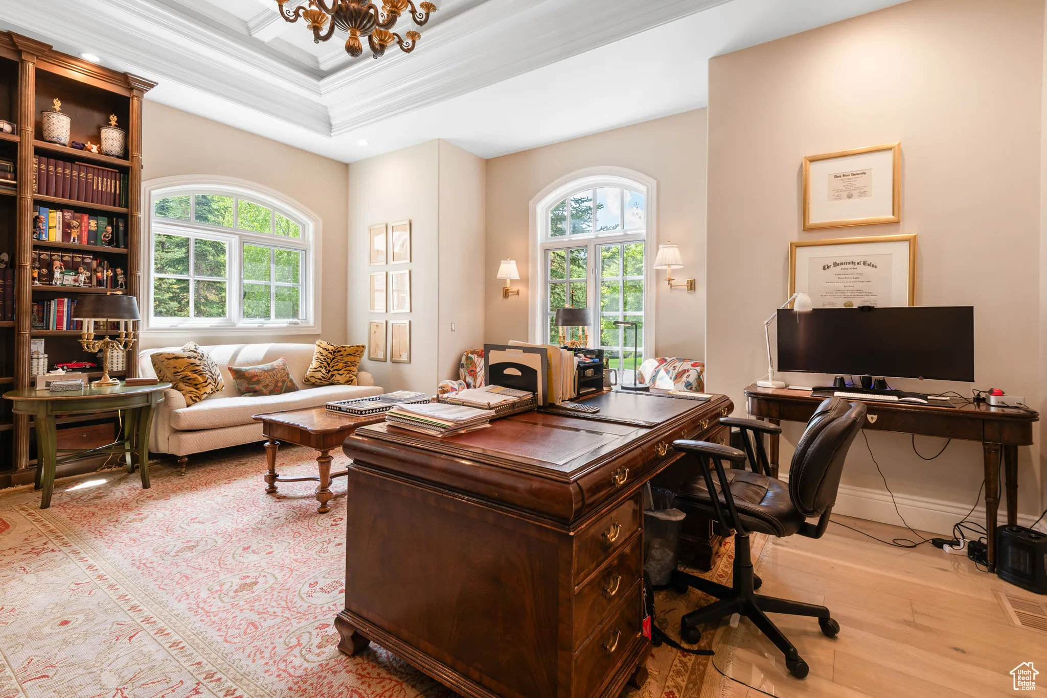 Office space featuring wood-type flooring, a chandelier, and crown molding