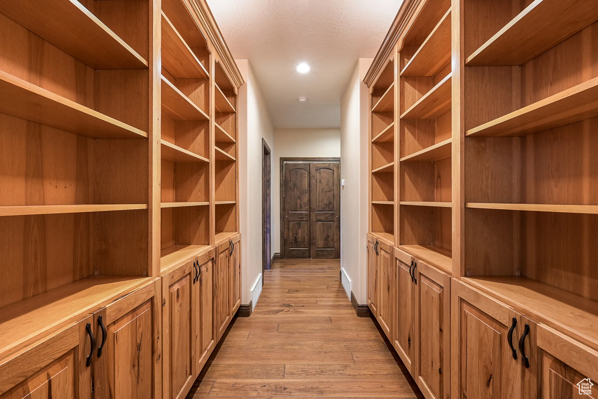Spacious closet with light wood-style flooring