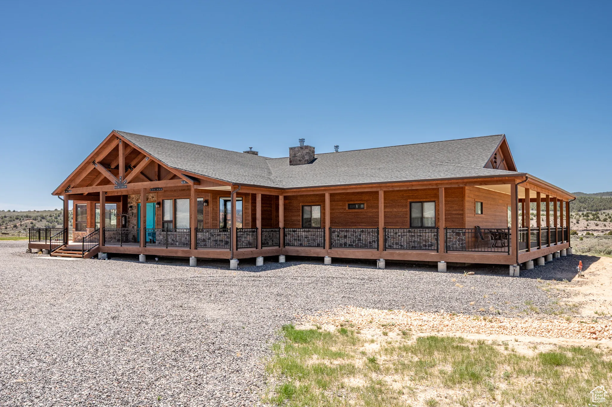 Front right of property with roof with shingles, a chimney, and a porch
