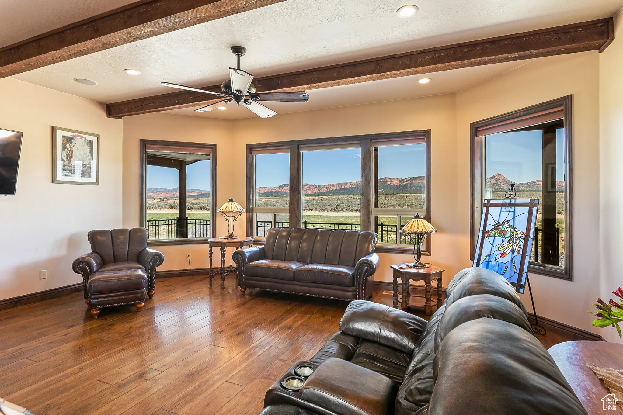 Living area featuring beamed ceiling, a ceiling fan, baseboards, hardwood / wood-style flooring, and recessed lighting