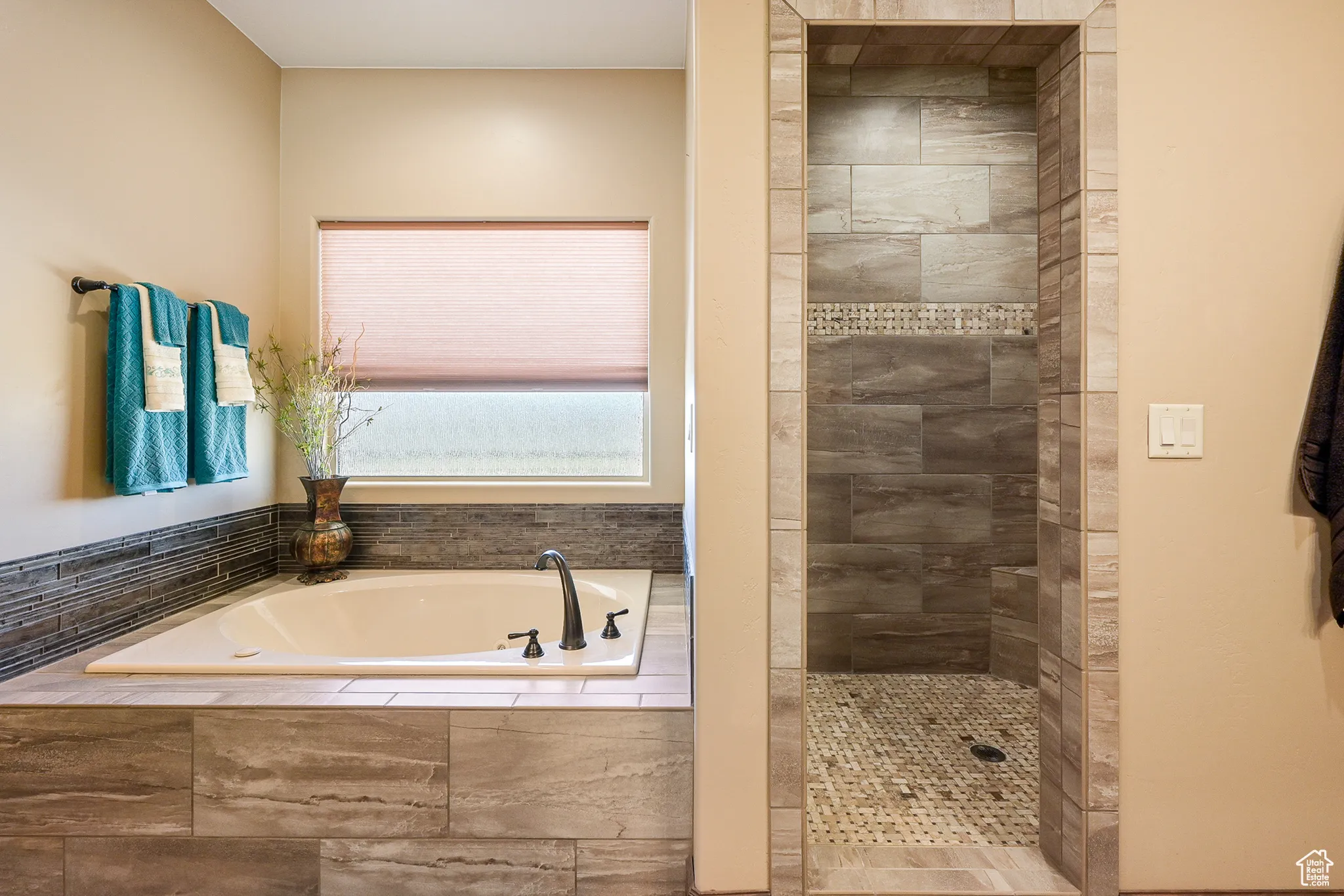 Master Bathroom with a tile shower and a garden tub
