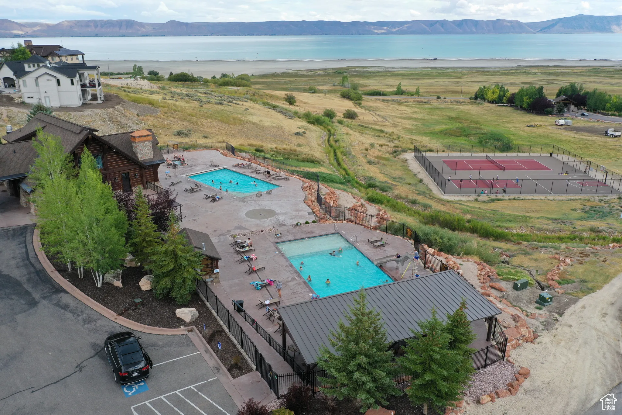 View of subject property with a pool and a water and mountain view