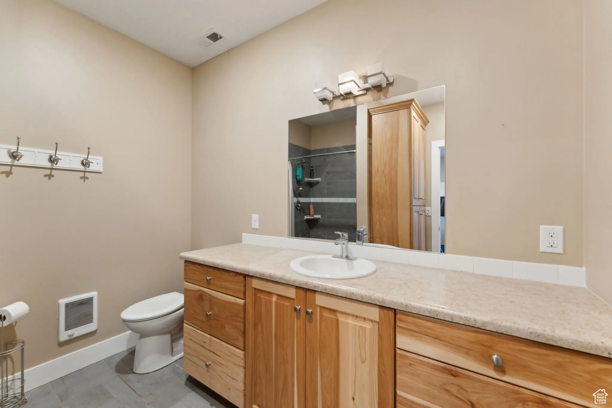 Roper Barn _ Bathroom with heating unit, toilet, vanity, a shower, and baseboards,  | Conditioned Use