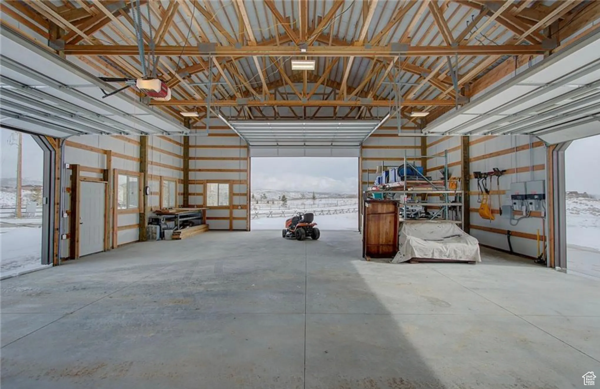 Snow covered garage featuring a garage door opener, 12.48 Acres 8819 Highfield Road Park City, Utah 84098. Utilities at building site