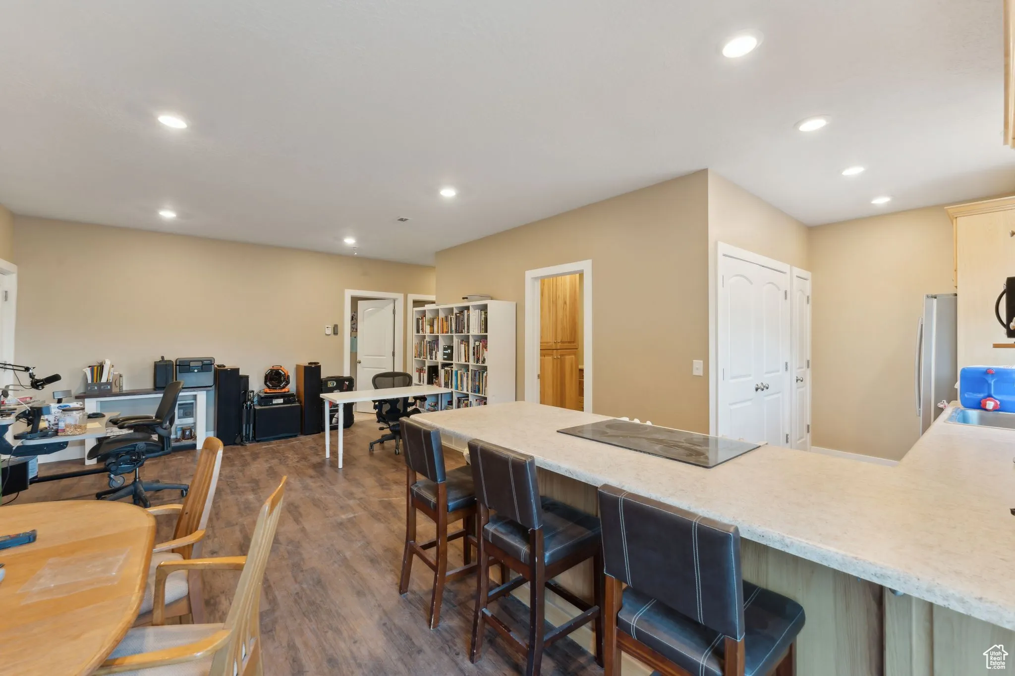 Roper Barn | Kitchen featuring black electric stovetop, recessed lighting, a peninsula, dark wood-style flooring, and a breakfast bar area, | Conditioned Use