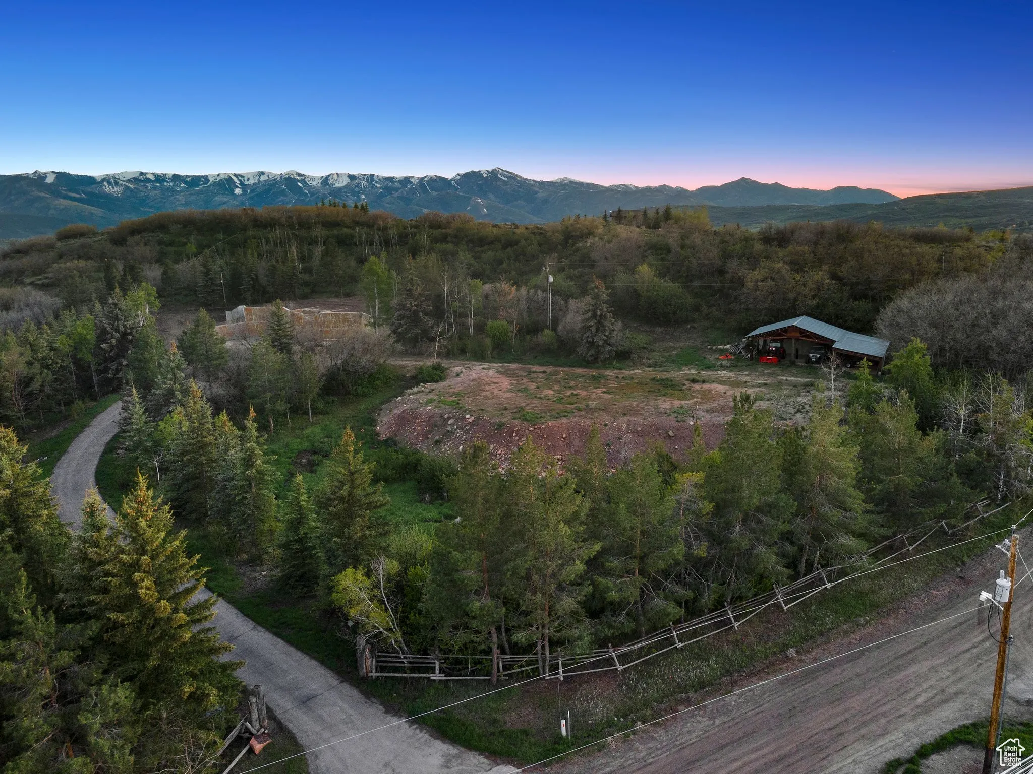 View of mountain backdrop featuring a heavily wooded area