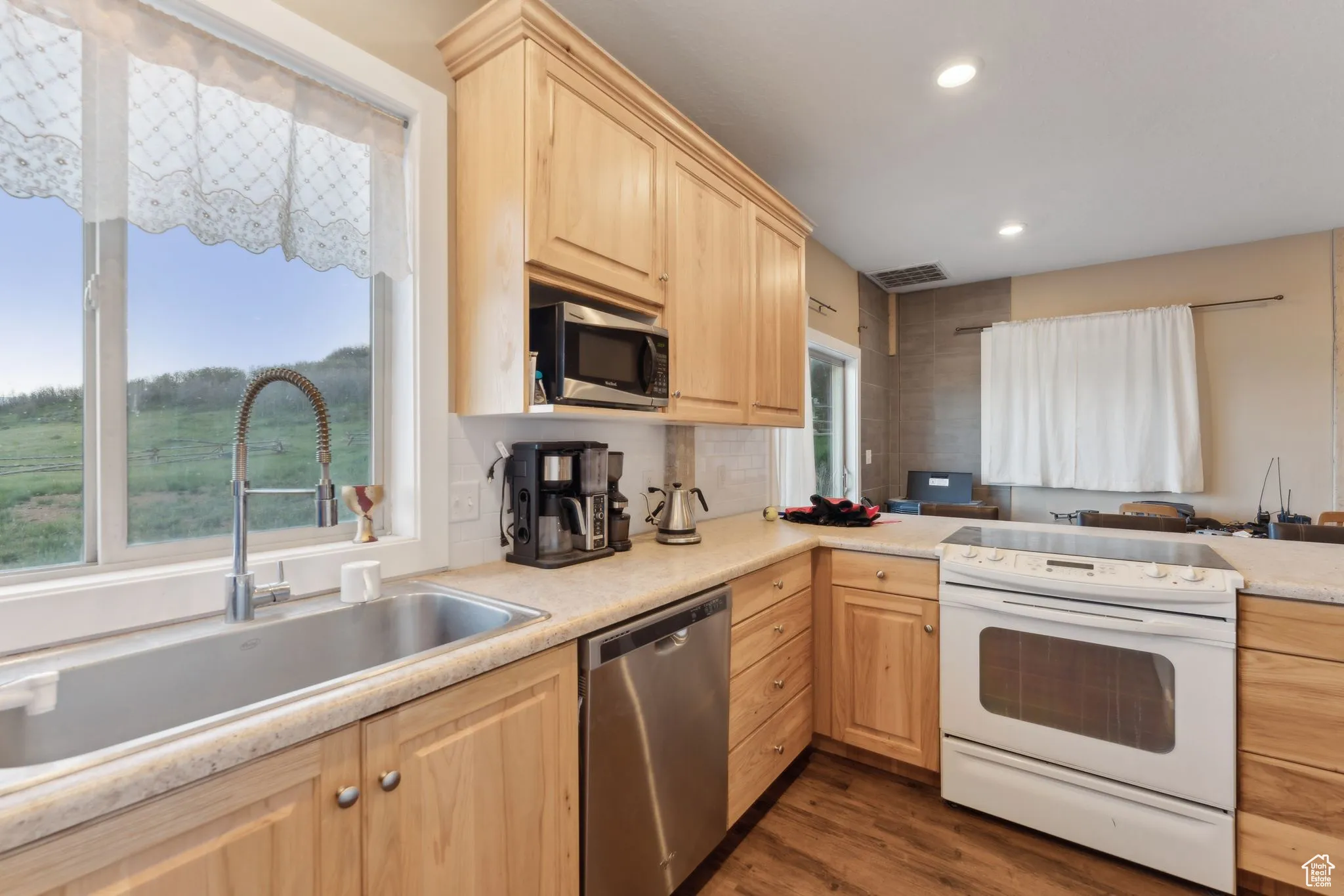 Roper Barn | Kitchen featuring appliances with stainless steel finishes, light brown cabinets, a sink, healthy amount of natural light, and recessed lighting | Conditoned Use