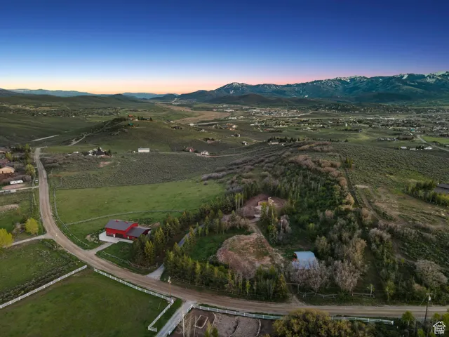 Aerial view at dusk of a mountain view and a view of rural / pastoral area