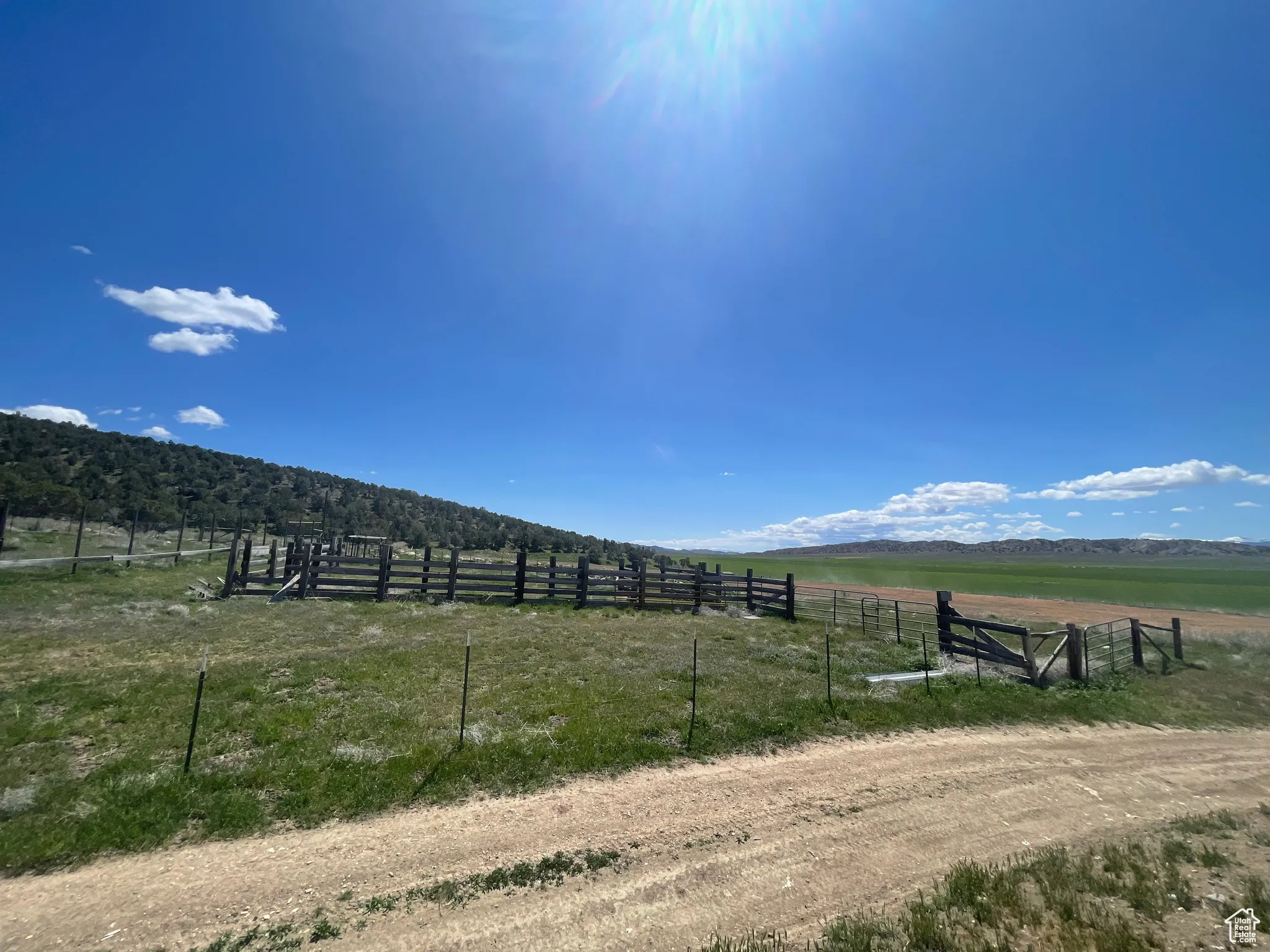 View of yard with a view of rural / pastoral area, fence, and a mountain view