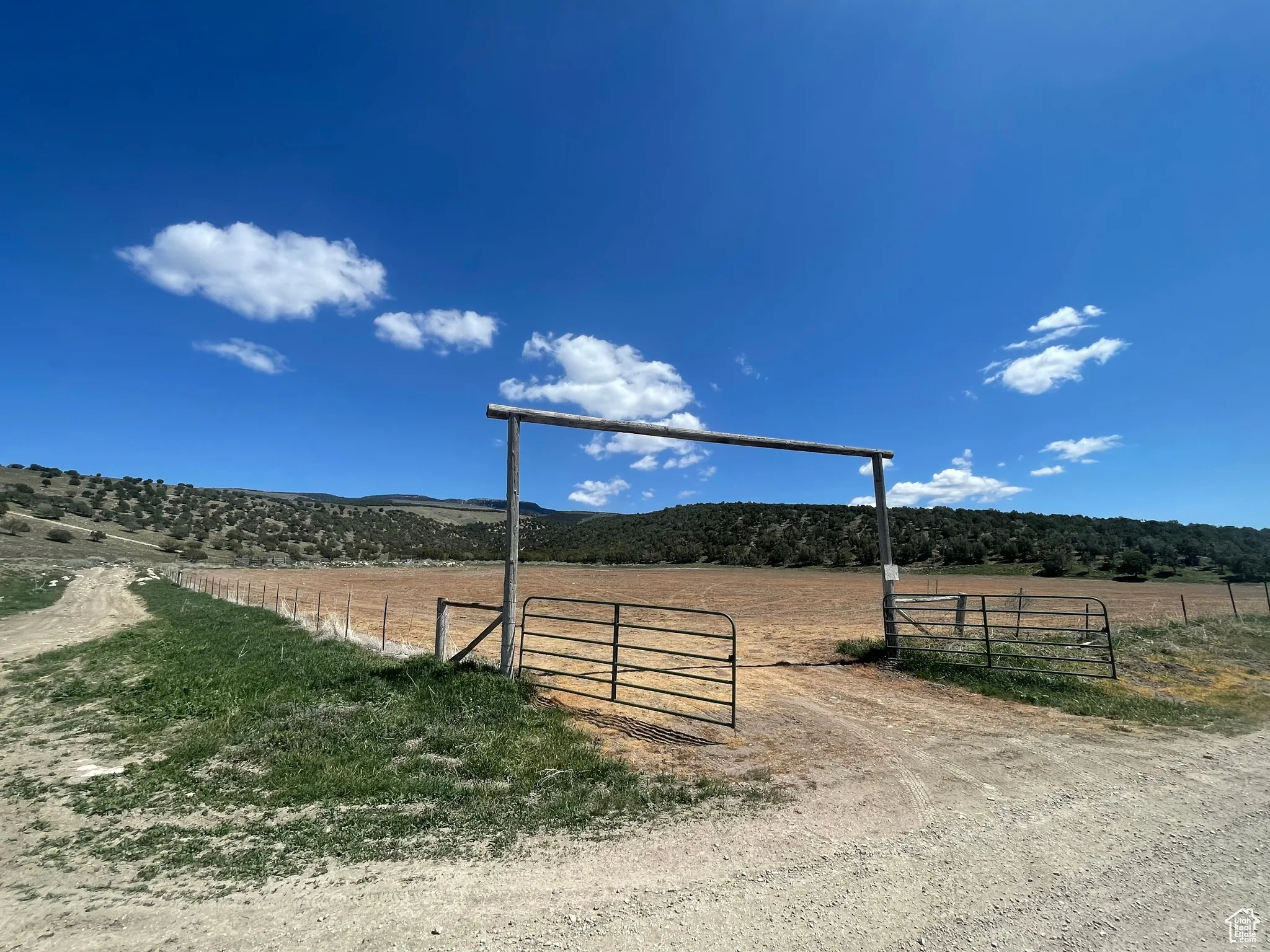 View of street with a view of countryside and a gated entry