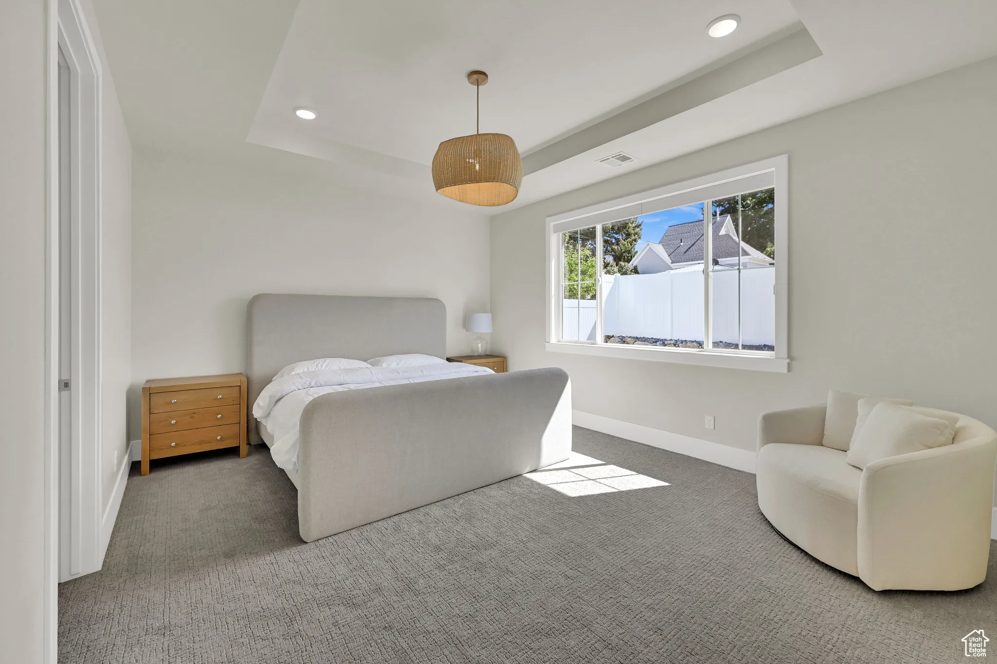 Bedroom with a raised ceiling, carpet floors, and recessed lighting