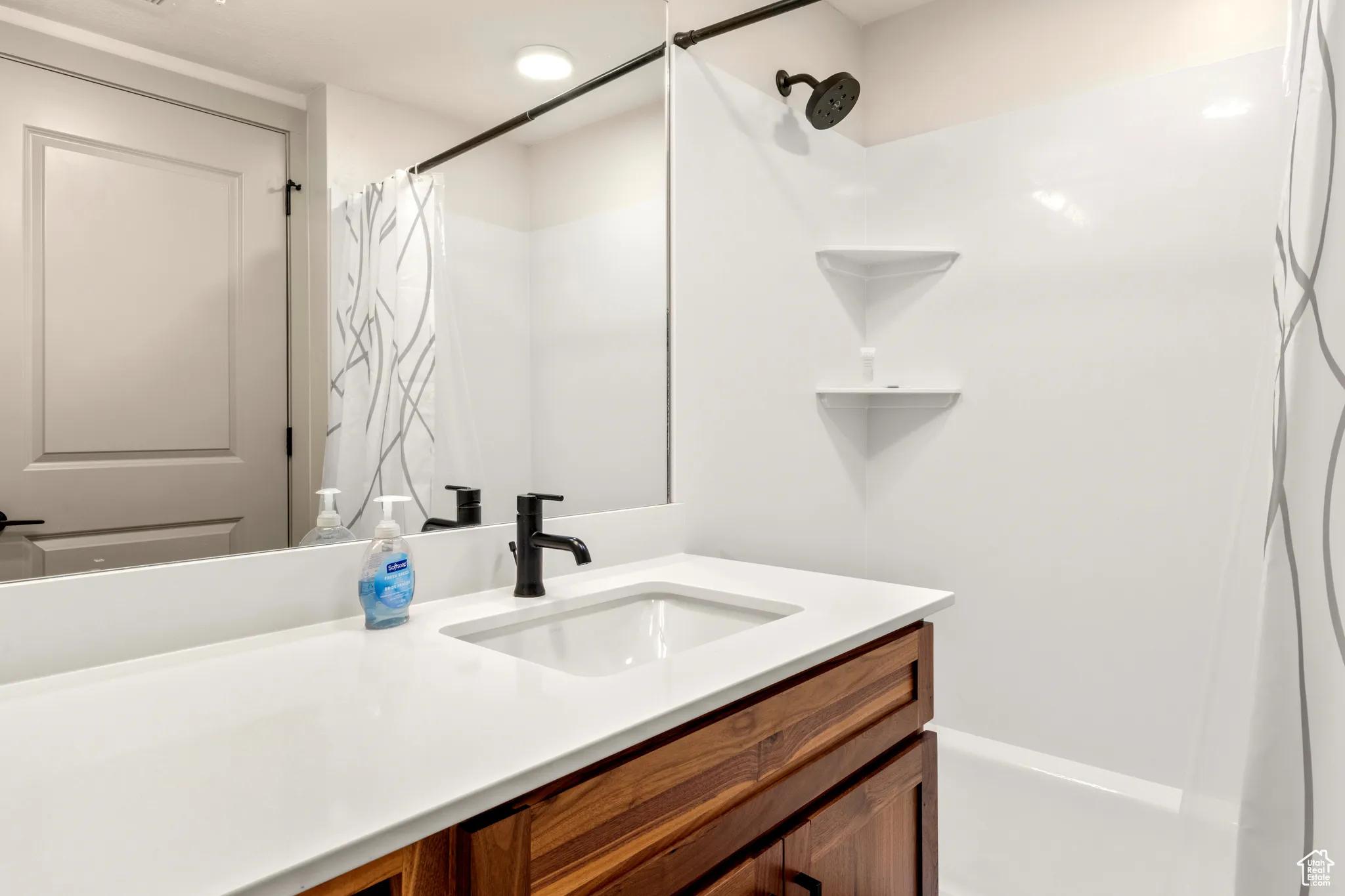 Full bath with vanity and a shower with curtain