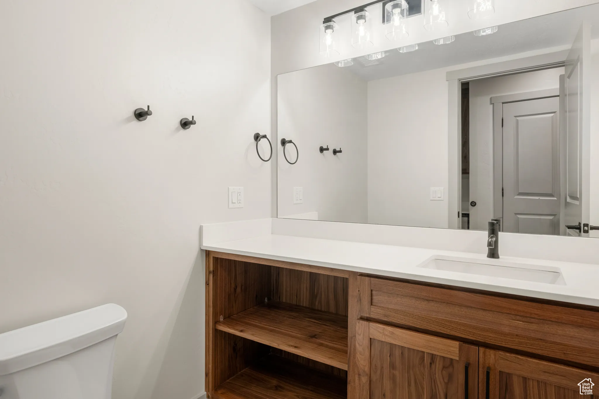 Half bath featuring toilet and vanity