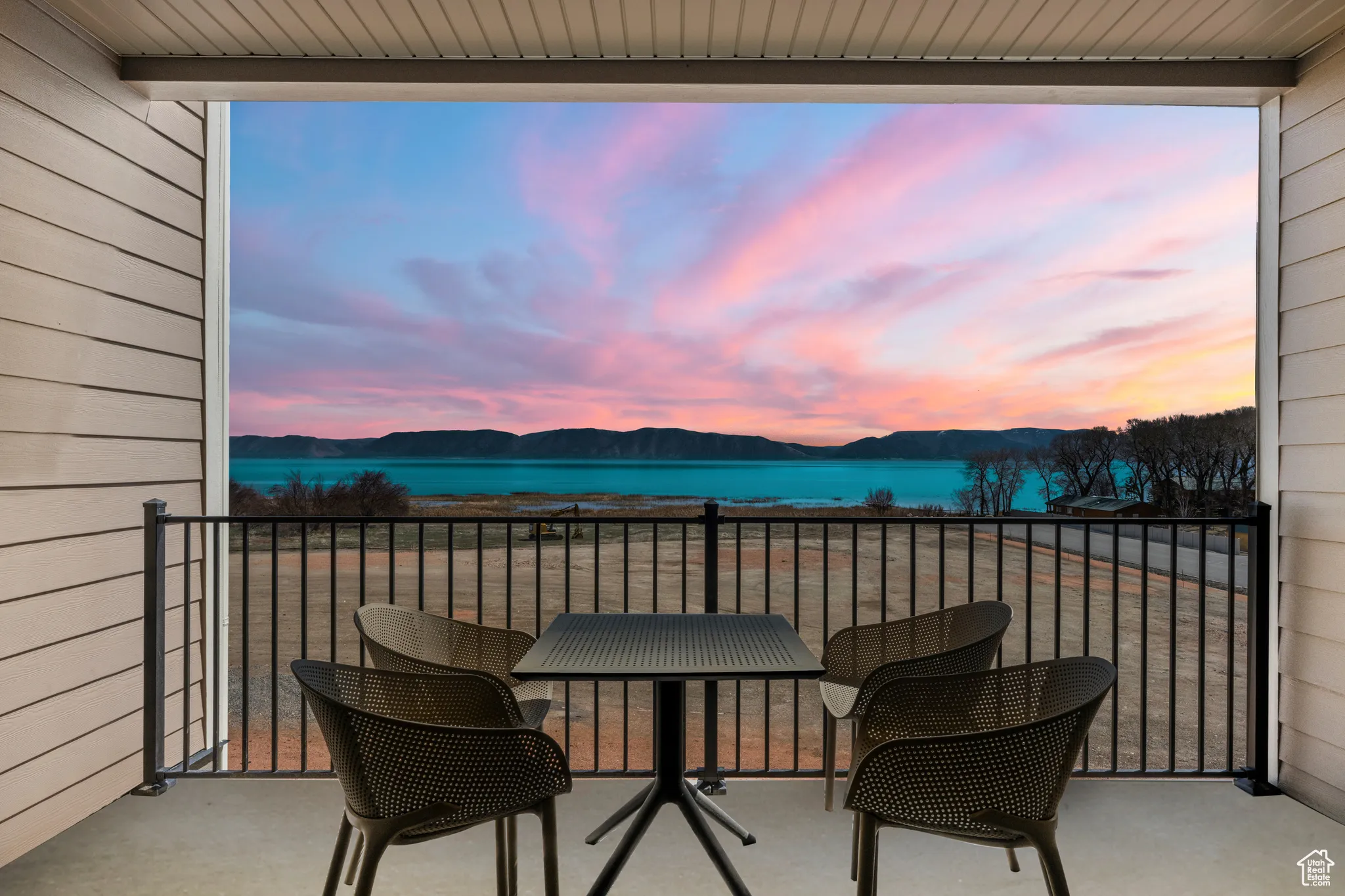 Balcony featuring a water and mountain view