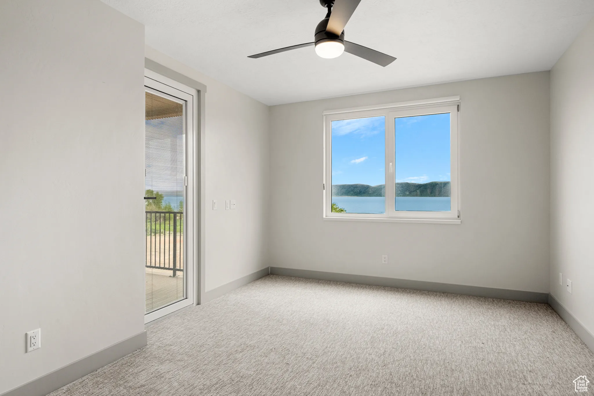 Unfurnished room with carpet flooring, baseboards, and ceiling fan