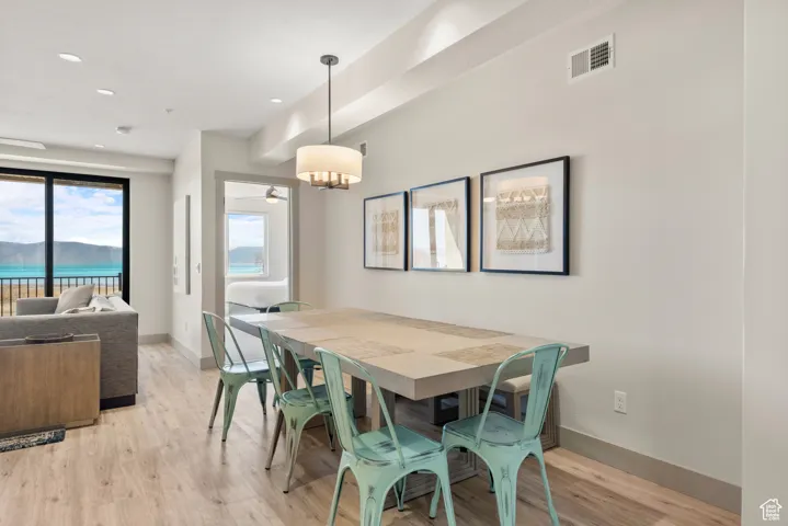 Dining room featuring light wood-style flooring, baseboards, and recessed lighting