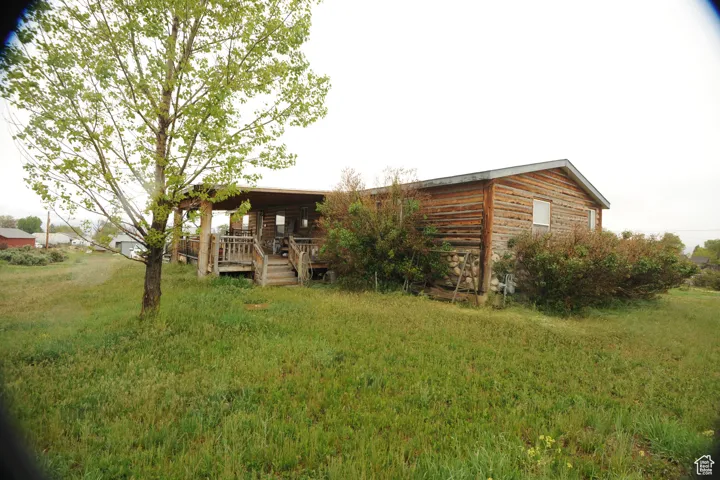 View of front of home with a front lawn and covered porch