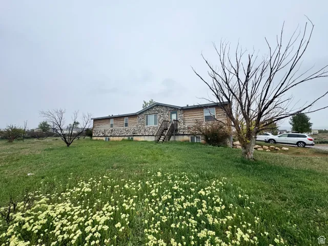 View of property exterior with a yard