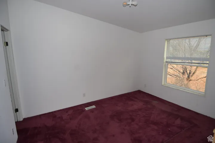 Empty room featuring carpet floors