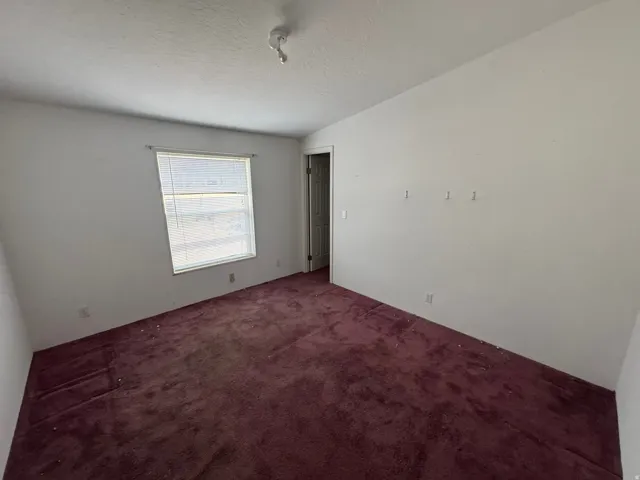 Spare room featuring carpet flooring and a textured ceiling