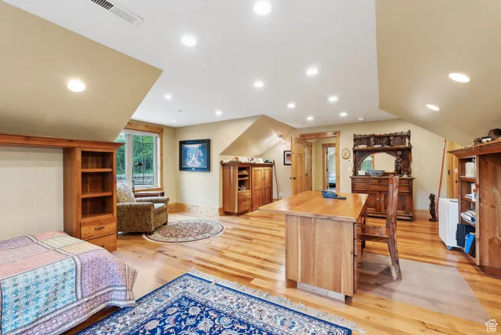 Bedroom with light wood-style floors, recessed lighting, and baseboards
